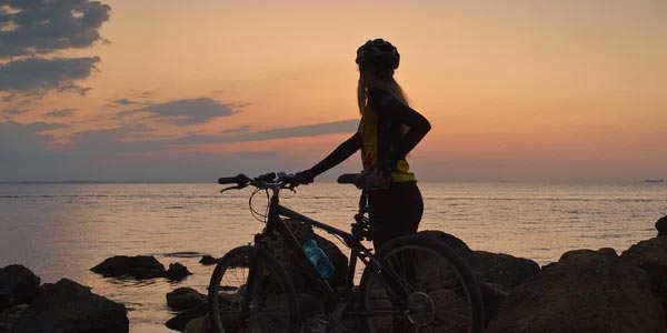Physical Recreation Lady with Bike by the ocean
