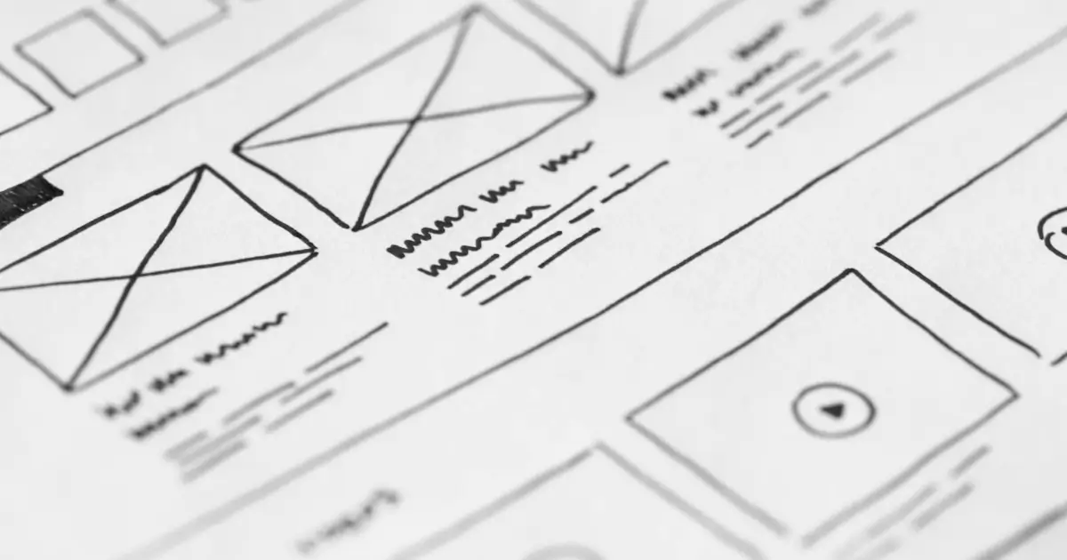 White sheet with rectangles sketched and scribbled notes for planning out building website